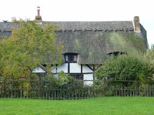 A thatched Tudor style house.  